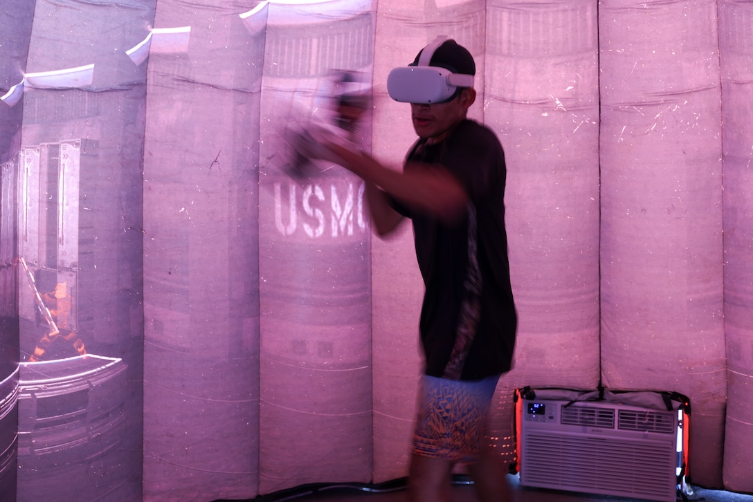 An attendee participates in the Battle Position simulator during the Texas Route 66 Festival on Route 66, Amarillo, Texas, June 14, 2025. The Texas Route 66 Festival was a 10-day event spanning across multiple cities along Route 66. The finale was hosted by the city of Amarillo and consisted of live music, car shows, and vendor booths. Marines utilized the enhanced-marketing Battle Position and the Marine pull-up bar challenge to engage with event attendees and talk to them about the Marine Corps as a career option. (U.S. Marine Corps Photo by Sgt. Kree Laing)