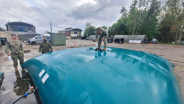 Hospital Corpsman 2nd Class Alexis Rivera, assigned to Navy Environmental Preventive Medicine Unit TWO (NEPMU-2), conducts routine chlorination of a water bladder at Camp Turtle during BALTOPS25 in Liepaja, Latvia, June 11, 2025. BALTOPS 25 is the premier maritime-focused annual military exercise in the Baltic region and provides a unique opportunity to strengthen warfighting readiness and combat credibility critical to deterrence and preserving safety and security in the Baltic Sea.