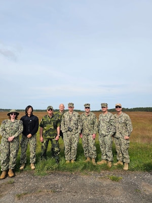 Lt. Xuan Li, Lt. Randy Buckley, Hospital Corpsman 1st Class Nicolas Garhartt, and Hosptial Corpsman 2nd Class Alexis Rivera, assigned to Navy Environmental Preventive Medicine Unit TWO (NEPMU-2), along with Sailors from 22 Naval Construction Regiment and Swedish military personnel pose for a group photo while conducting a expeditionary medical facility survey during BALTOPS25 in Rinkaby, Sweden, June 19, 2025. BALTOPS 25 is the premier maritime-focused annual military exercise in the Baltic region and provides a unique opportunity to strengthen warfighting readiness and combat credibility critical to deterrence and preserving safety and security in the Baltic Sea.