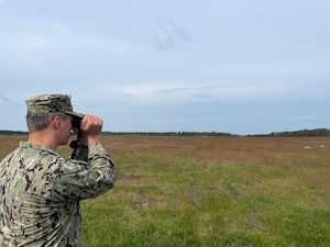 Hospital Corpsman 1st Class Nicolas Garhartt, assigned to Navy Environmental Preventive Medicine Unit TWO (NEPMU-2), conduct vector surveillance operations through open terrain during BALTOPS25 in Rinkaby, Sweden, June 19, 2025. BALTOPS 25 is the premier maritime-focused annual military exercise in the Baltic region and provides a unique opportunity to strengthen warfighting readiness and combat credibility critical to deterrence and preserving safety and security in the Baltic Sea.