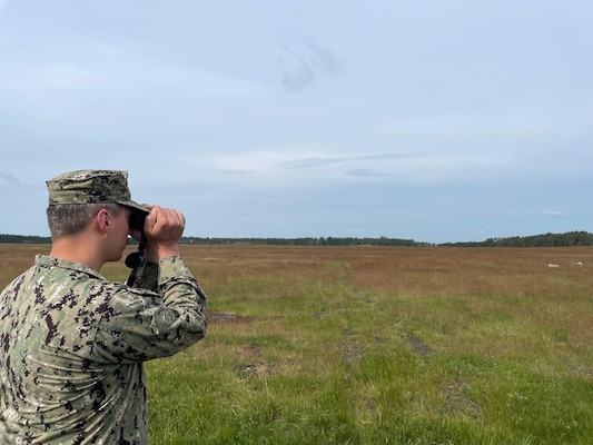 Hospital Corpsman 1st Class Nicolas Garhartt, assigned to Navy Environmental Preventive Medicine Unit TWO (NEPMU-2), conduct vector surveillance operations through open terrain during BALTOPS25 in Rinkaby, Sweden, June 19, 2025. BALTOPS 25 is the premier maritime-focused annual military exercise in the Baltic region and provides a unique opportunity to strengthen warfighting readiness and combat credibility critical to deterrence and preserving safety and security in the Baltic Sea.