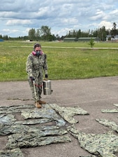 Hospital Corpsman 2nd Class Alexis Rivera, assigned to Navy Environmental Preventive Medicine Unit (NEPMU) 7, applies permethrin treatment to uniforms at a field site during BALTOPS25 in Skrunda, Latvia, June 19, 2025. BALTOPS 25 is the premier maritime-focused annual military exercise in the Baltic region and provides a unique opportunity to strengthen warfighting readiness and combat credibility critical to deterrence and preserving safety and security in the Baltic Sea.