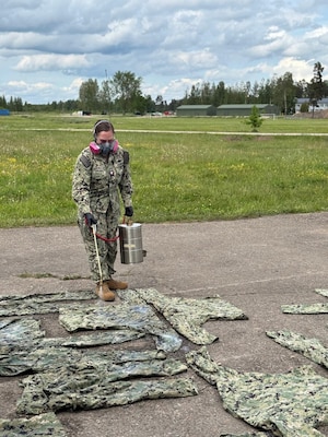 Hospital Corpsman 2nd Class Alexis Rivera, assigned to Navy Environmental Preventive Medicine Unit (NEPMU) 7, applies permethrin treatment to uniforms at a field site during BALTOPS25 in Skrunda, Latvia, June 19, 2025. BALTOPS 25 is the premier maritime-focused annual military exercise in the Baltic region and provides a unique opportunity to strengthen warfighting readiness and combat credibility critical to deterrence and preserving safety and security in the Baltic Sea.