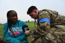Airman 1st Class Thomas Sexton, 5th Medical Group (5MDG) medical technician, checks the blood pressure of Folashade Ajulo, 5MDG disease manager, at Minot Air Force Base, North Dakota, June 11, 2025. Sexton checked Ajulo’s blood pressure to sharpen his speed and accuracy with recording diagnostics during an emergency exercise. (U.S. Air Force photo by Airman 1st Class Anthony Ramey.)