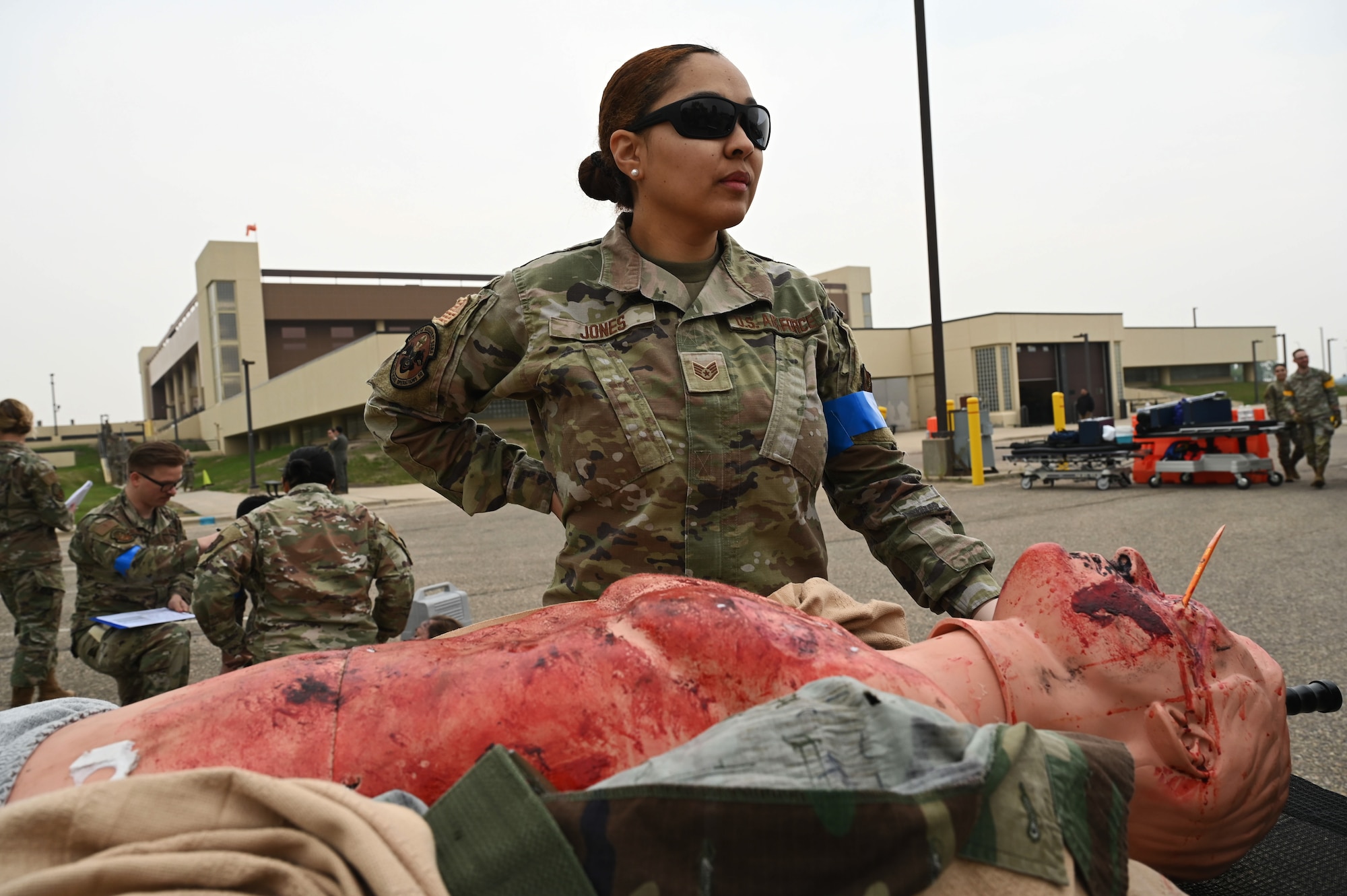 U.S. Air Force Staff Sgt. Jamila Jones, a 5th Medical Group (5MDG) medical technician, poses in front of a manikin at Minot Air Force Base, North Dakota, June 11, 2025. The 5MDG used manikins to assist in training Airmen to assess and treat injuries. (U.S. Air Force photo by Airman 1st Class Anthony Ramey.)