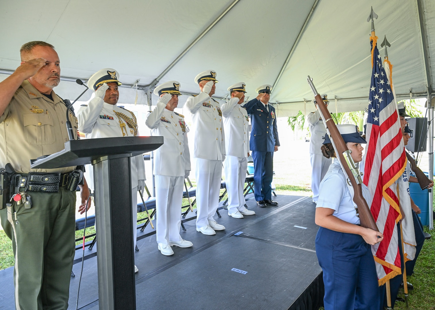 Incoming and outgoing Sector Key West commanders, Capt. Jason Ingram and Capt. Joshua Empen, render salutes alongside presiding officer Capt. Willie L. Carmichael, Seventh Coast Guard District chief of staff, during a change of command ceremony at U.S. Coast Guard Sector Key West, June 20, 2025. The change of command ceremony is a time-honored tradition that represents a total transfer of responsibility, authority and accountability from one individual to another. (U.S. Coast Guard photo by Petty Officer 2nd Class Eric Rodriguez)