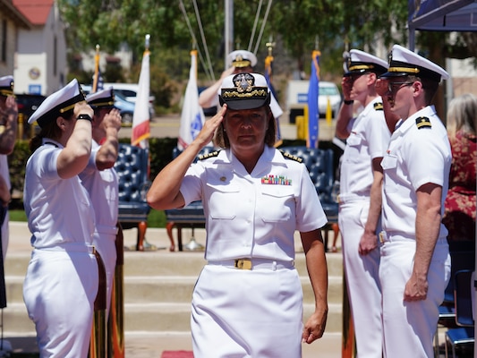 SAN DIEGO (June 17, 2025) Capt. Kellie McMullen passes through side boys at Naval Health Research Center’s (NHRC) change of command ceremony in which she relieved Capt. Eric Welsh as commanding officer. NHRC, part of Navy Medicine Research & Development, supports Navy, Marine Corps, and joint U.S. warfighter health readiness and lethality with research and development that delivers high-value, high-impact solutions to the health and readiness challenges U.S. military population faces on the battlefield, at-sea, home and abroad. (U.S. Navy photo by Danielle Cazarez)