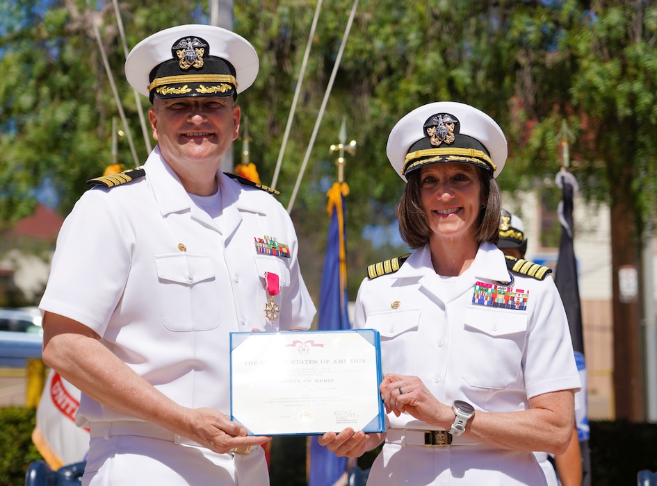 SAN DIEGO (June 17, 2025) Naval Health Research Center’s (NHRC) departing commanding officer Capt. Eric R. Welsh (left) is presented with his merit award during the change of command ceremony by the presiding officer, Capt. Franca R. Jones, Naval Medical Research Command’s commander (right). Capt. Welsh’s next tour will be at NMRC, where he will relieve Capt. Jones. NHRC, part of Navy Medicine Research & Development, supports Navy, Marine Corps, and joint U.S. warfighter health readiness and lethality with research and development that delivers high-value, high-impact solutions to the health and readiness challenges U.S. military population faces on the battlefield, at-sea, home and abroad. (U.S. Navy photo by Danielle Cazarez)