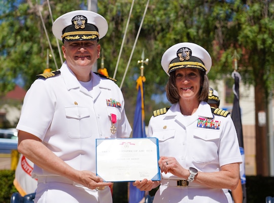 SAN DIEGO (June 17, 2025) Naval Health Research Center’s (NHRC) departing commanding officer Capt. Eric R. Welsh (left) is presented with his merit award during the change of command ceremony by the presiding officer, Capt. Franca R. Jones, Naval Medical Research Command’s commander (right). Capt. Welsh’s next tour will be at NMRC, where he will relieve Capt. Jones. NHRC, part of Navy Medicine Research & Development, supports Navy, Marine Corps, and joint U.S. warfighter health readiness and lethality with research and development that delivers high-value, high-impact solutions to the health and readiness challenges U.S. military population faces on the battlefield, at-sea, home and abroad. (U.S. Navy photo by Danielle Cazarez)