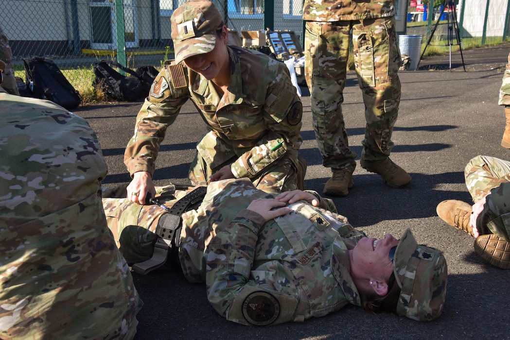 1st Lt. Skylar Casson, 185th Air Refueling Wing Medical Group Critical  Care Air Transport Nurse applies a tourniquet for a simulated wound.