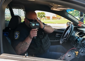 Cpl. Brady Harley, 42nd Security Forces Squadron DAF police officer, performs speed checks using a Stalker LIDAR XS at Maxwell Air Force Base June 20, 2025.