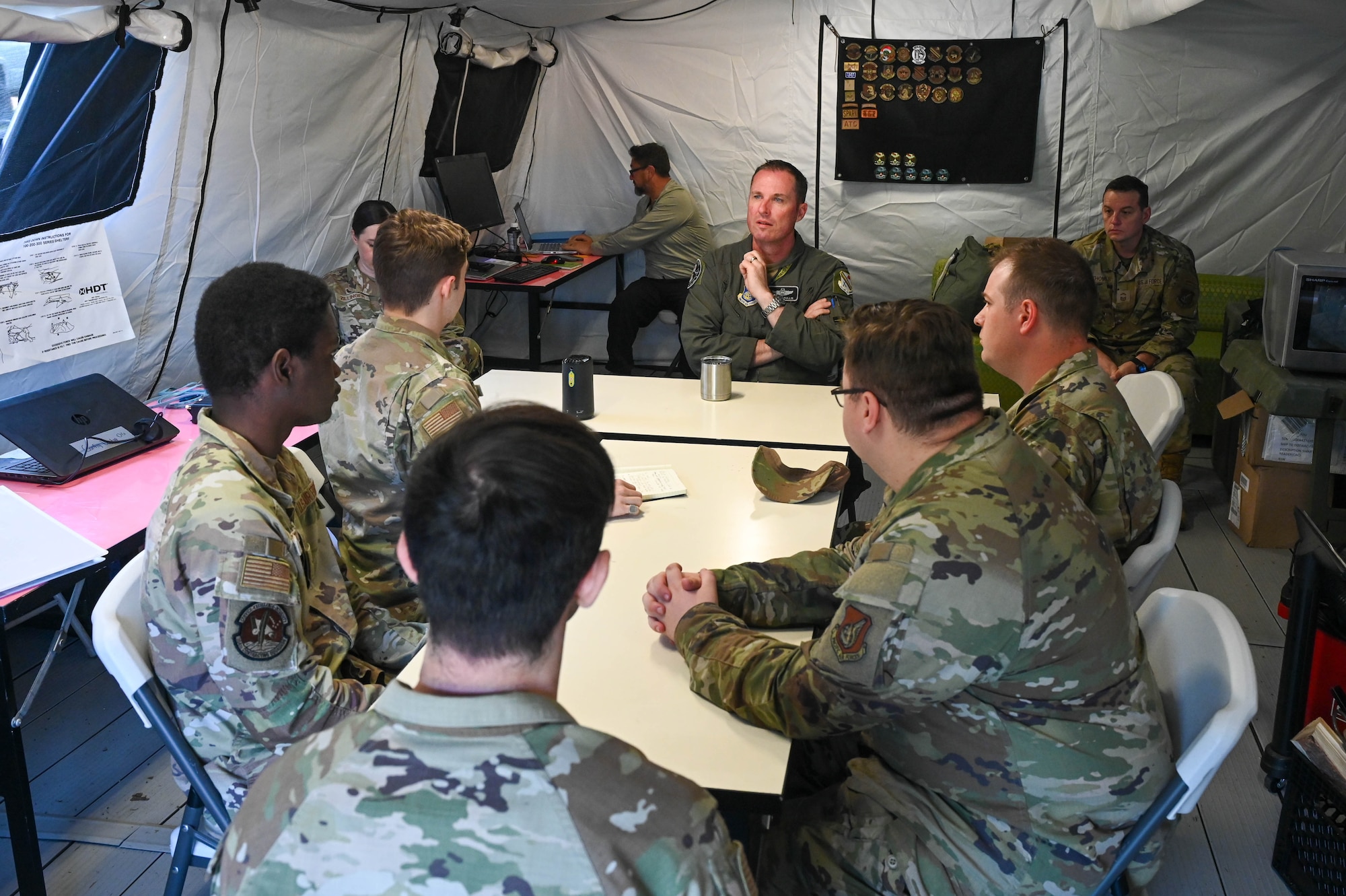U.S. Air Force Col. Michael Mullen, 354th Fighter Wing deputy commander, receives a brief from 354th Contracting Squadron and 354th Comptroller Squadron Airmen during a Contingency Contracting Officer Training at Eielson Air Force Base, Alaska, June 18, 2025.