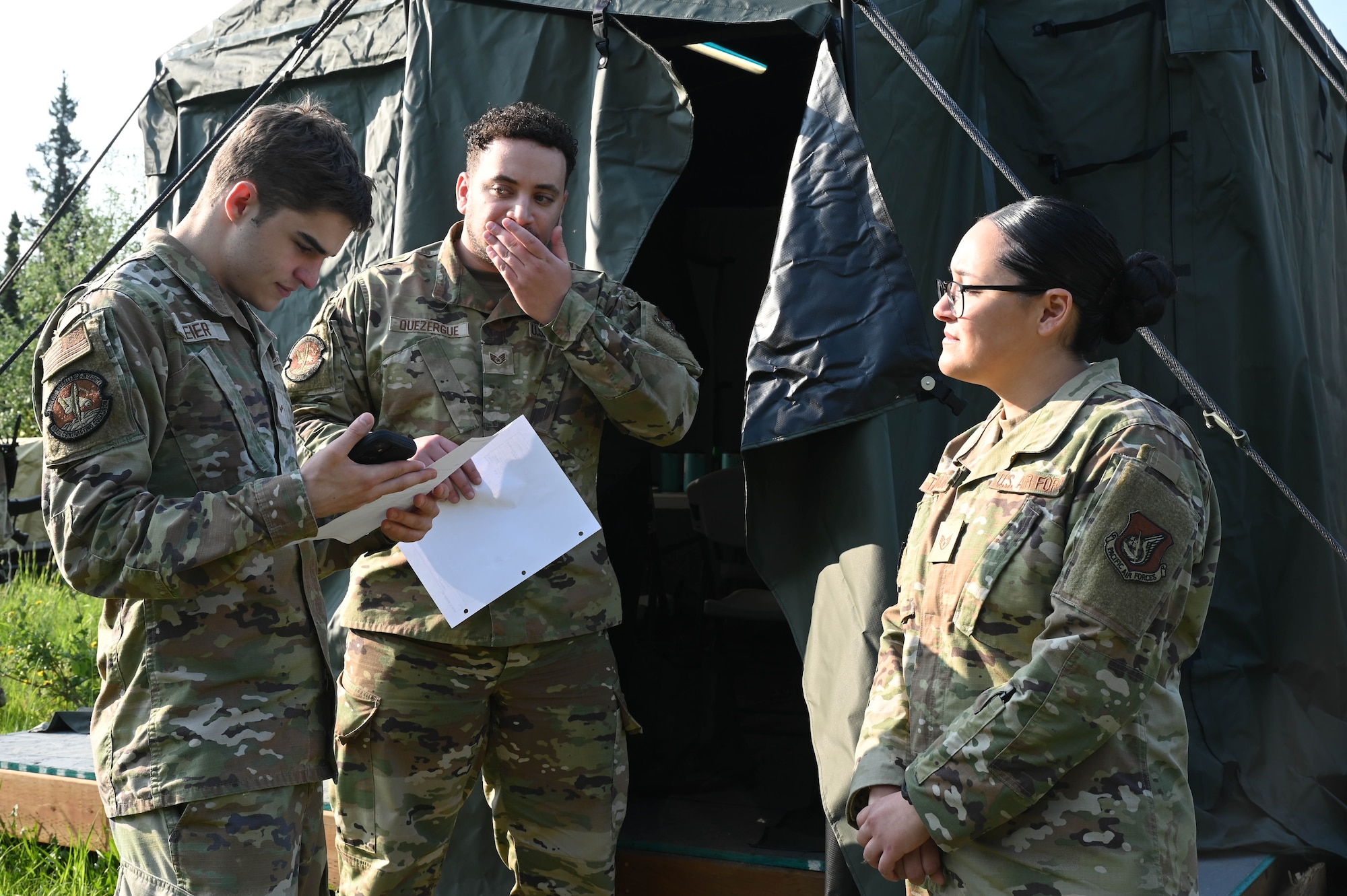 U.S. Air Force Airman 1st Class Zachary Meier, left, 354th Contracting Squadron contracting specialist, Staff Sgt. Blaize Quezergue, middle, 354th CONS contracting officer, and Staff Sgt, Mackenzie Talamantes, right, 354th Force Support Squadron satellite dining facility manager, discuss supply procurement during a Contingency Contracting Officer Training at Eielson Air Force Base, Alaska, June 18, 2025.