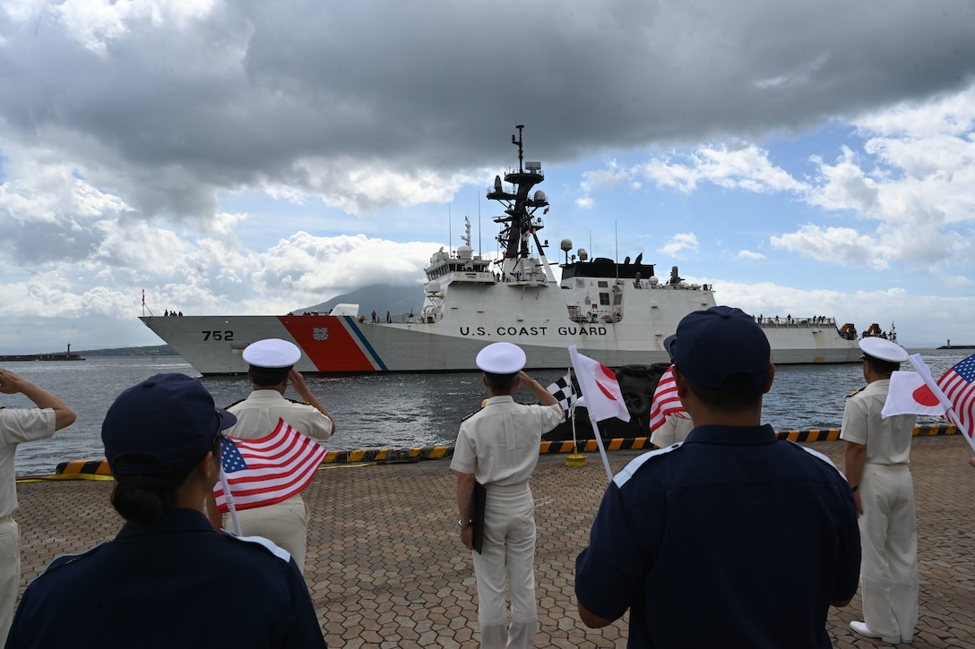 Japan Coast Guard members wave U.S. and Japanese flags to welcome the arrival of the Legend-class U.S. Coast Guard Cutter Stratton (WMSL 752) to Kagoshima, Japan, June 16, 2025 during a trilateral exercise with U.S. and Philippine Coast Guards. Stratton is deployed and assigned to Destroyer Squadron (DESRON) 15, the Navy’s largest DESRON and the U.S. 7th Fleet’s principal surface force. U.S. Coast Guard Cutter Stratton is deployed to the Indo-Pacific to advance relationships with ally and partner nations to build a more secure and prosperous region with unrestricted, lawful access to the maritime commons. (U.S. Coast Guard photo by Senior Chief Petty Officer Matthew S. Masaschi)
