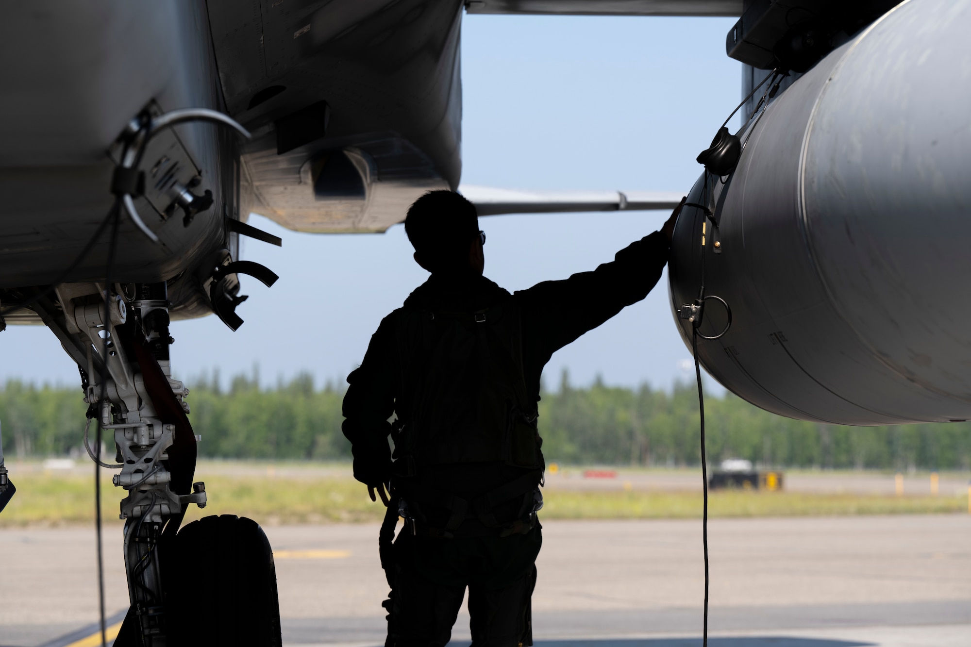 A Japan Air Self-Defense Force F-15J Eagle pilot performs pre-flight inspections prior to takeoff during Red Flag-Alaska 25-2 at Eielson Air Force, Alaska, June 17, 2025.