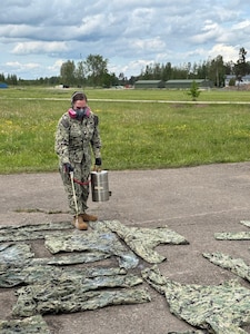 Hospital Corpsman 2nd Class Alexis Rivera, assigned to Navy Environmental Preventive Medicine Unit (NEPMU) 7, applies permethrin treatment to uniforms at a field site during BALTOPS25 in Skrunda, Latvia, June 19, 2025. BALTOPS 25 is the premier maritime-focused annual military exercise in the Baltic region and provides a unique opportunity to strengthen warfighting readiness and combat credibility critical to deterrence and preserving safety and security in the Baltic Sea.