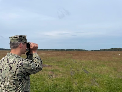 Hospital Corpsman 1st Class Nicolas Garhartt, assigned to Navy Environmental Preventive Medicine Unit TWO (NEPMU-2), conduct vector surveillance operations through open terrain during BALTOPS25 in Rinkaby, Sweden, June 19, 2025. BALTOPS 25 is the premier maritime-focused annual military exercise in the Baltic region and provides a unique opportunity to strengthen warfighting readiness and combat credibility critical to deterrence and preserving safety and security in the Baltic Sea.