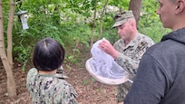 Lt. Xuan Li, Lt. Randy Buckley, and Hospital Corpsman 1st Class Nicolas Garhartt, assigned to Navy Environmental Preventive Medicine Unit TWO (NEPMU-2), hang up a light trap trap to monitor mosquito populations and assess potential vector-borne disease risks at Camp Turtle during BALTOPS25 in Liepaja, Latvia, June 6, 2025. BALTOPS 25 is the premier maritime-focused annual military exercise in the Baltic region and provides a unique opportunity to strengthen warfighting readiness and combat credibility critical to deterrence and preserving safety and security in the Baltic Sea.