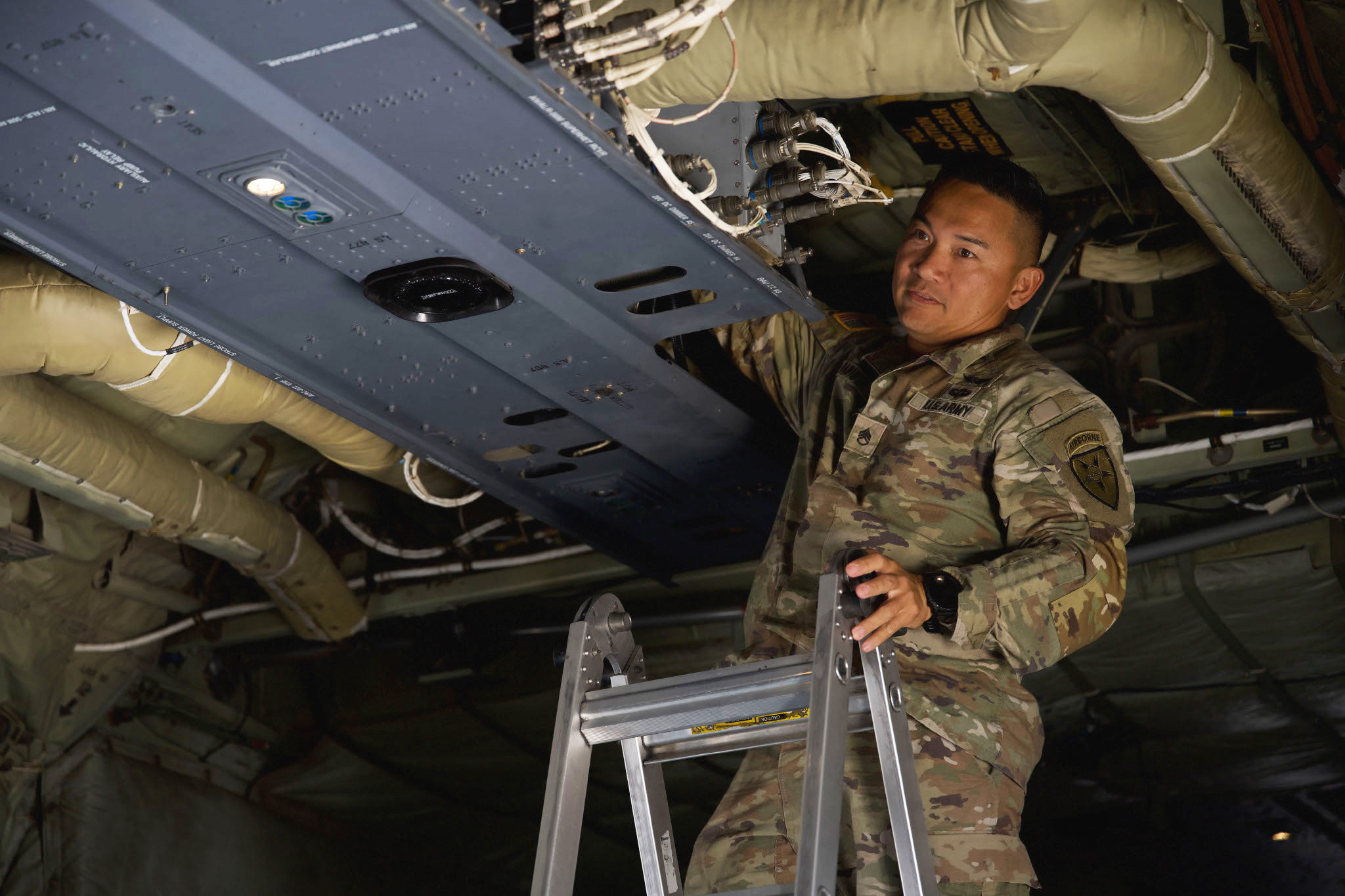 U.S. Army Staff Sgt. Kenneth Babista, 4th Joint Communications Support Element enroute engineer, installs an ultra-high frequency satellite communication antenna at Dyess Air Force Base, Texas, June 3, 2025. The antenna supports agile operations aligned with adaptive basing and resilient communications goals. (U.S. Air Force photo by Senior Airman Emma Anderson)