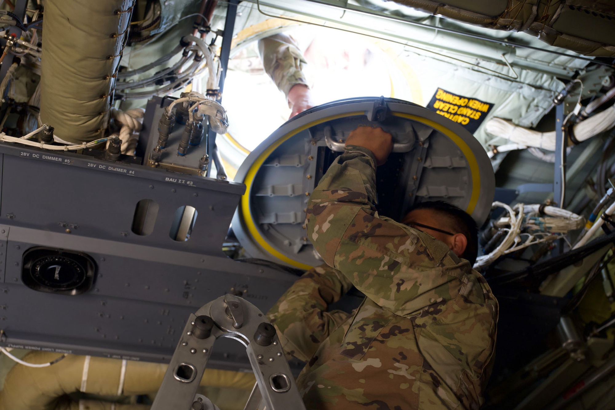 U.S. Army Staff Sgt. Anthony Matute, 4th Joint Communications Support Element frequency engineer, installs a Starshield Mini hatch-mount antenna on a C-130J Super Hercules at Dyess Air Force Base, Texas, June 3, 2025. The antenna’s modular design allows for quick installation by standard maintenance crews without specialized training. (U.S. Air Force photo by Senior Airman Emma Anderson)
