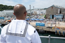 YOKOSUKA, Japan (June 23, 2025) – Friends and family of Sailors aboard U.S. 7th Fleet flagship USS Blue Ridge (LCC 19) observe the ship’s return to Commander Fleet Activities Yokosuka following a summer patrol, June 23. The Blue Ridge and embarked U.S. 7th Fleet staff conduct regular Indo-Pacific patrols to deter aggression, strengthen alliances and partnerships, and advance future warfighting capabilities. (U.S. Navy photo by Mass Communication Specialist 3rd Class Thomas Furnish)