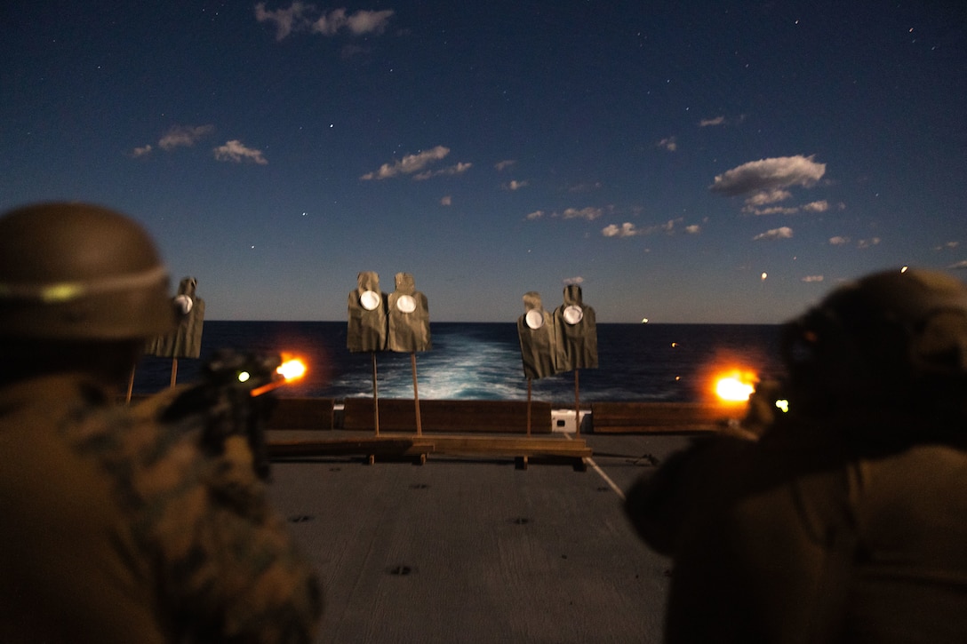 U.S. Marines with 1st Light Armored Reconnaissance Company, Battalion Landing Team 1st Battalion, 7th Marine Regiment, 31st Marine Expeditionary Unit, fire at targets during a night live-fire deck shoot aboard amphibious transport dock USS San Diego (LPD 22), in the Timor Sea, June 12, 2025. Marines conducted various drills in order to refine and improve weapons familiarity and marksmanship proficiency. The 31st MEU is operating aboard ships of the USS America Amphibious Ready Group in the 7th Fleet area of operations, the U.S. Navy’s largest forward-deployed numbered fleet, and routinely interacts and operates with allies and partners in preserving a free and open Indo-Pacific region. (U.S. Marine Corps photo by Lance Cpl. Raul Sotovilla)