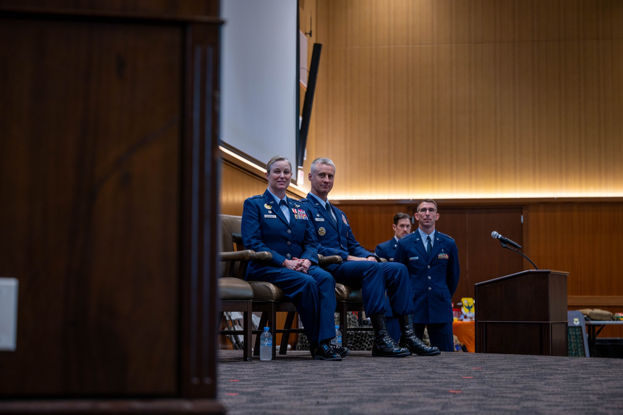 Two commanders listen to speech.