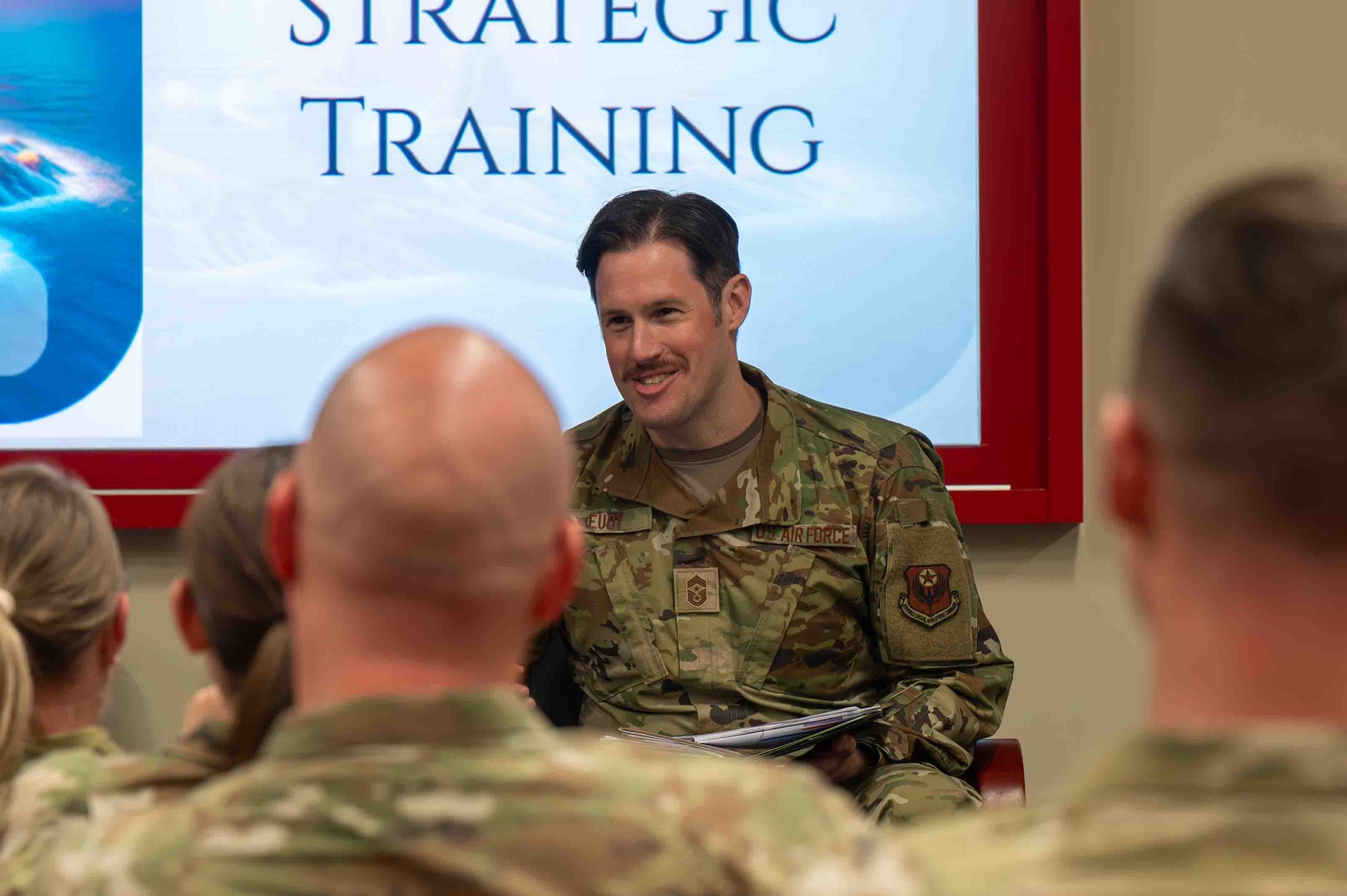 Service member speaks during a discussion.