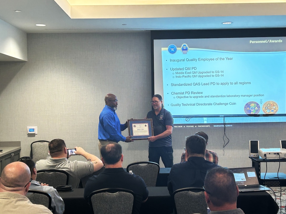 An award is present at the quality workshop.