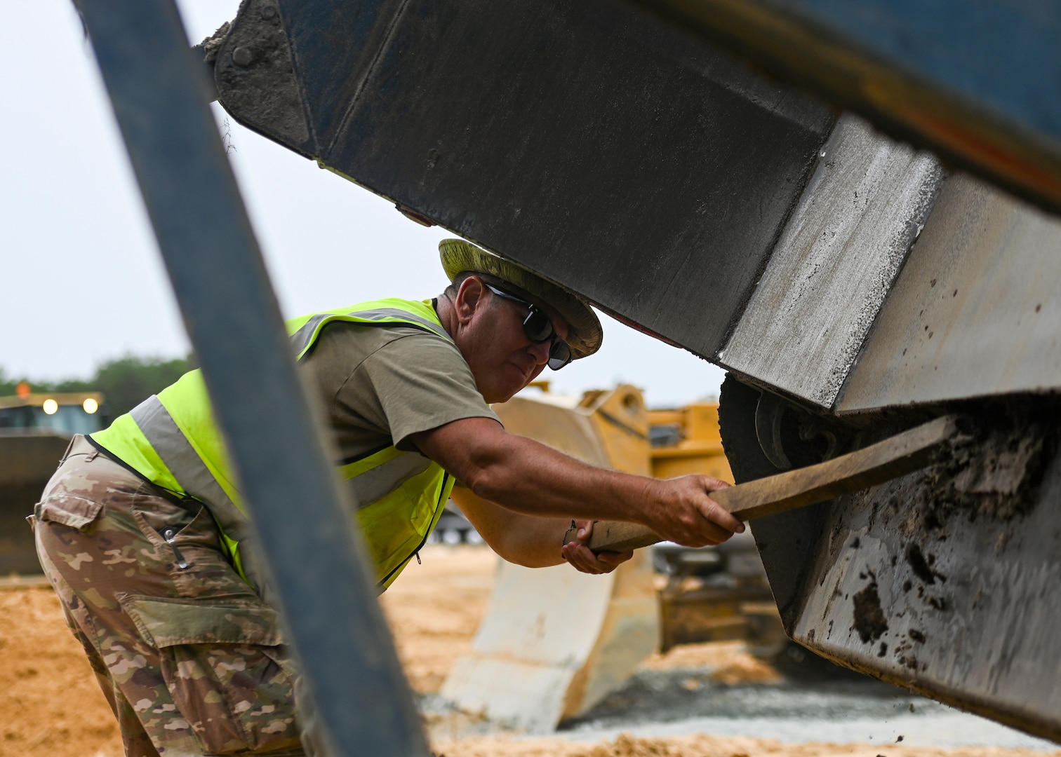 Pennsylvania Air National Guardsman, Tech. Sgt. Richard Dorne, assigned to the 171st Civil Engineer Squadron, cleans out debris from the back of a dump truck during a deployment for training, Assateague Island, Virginia, June 17, 2025.