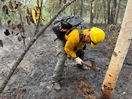 Alaska Air National Guard Senior Airman Jody Doyon, 176th Civil Engineer Squadron firefighter, supports wildfire containment efforts June 21, 2025, at Bear Creek, Alaska.
