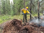 Alaska Air National Guard Tech. Sgt. Quintan Hecimovich, 176th Civil Engineer Squadron firefighter, supports wildfire containment efforts June 21, 2025, at Bear Creek, Alaska. The Alaska National Guard activated volunteers to support containment efforts in  the Interior.