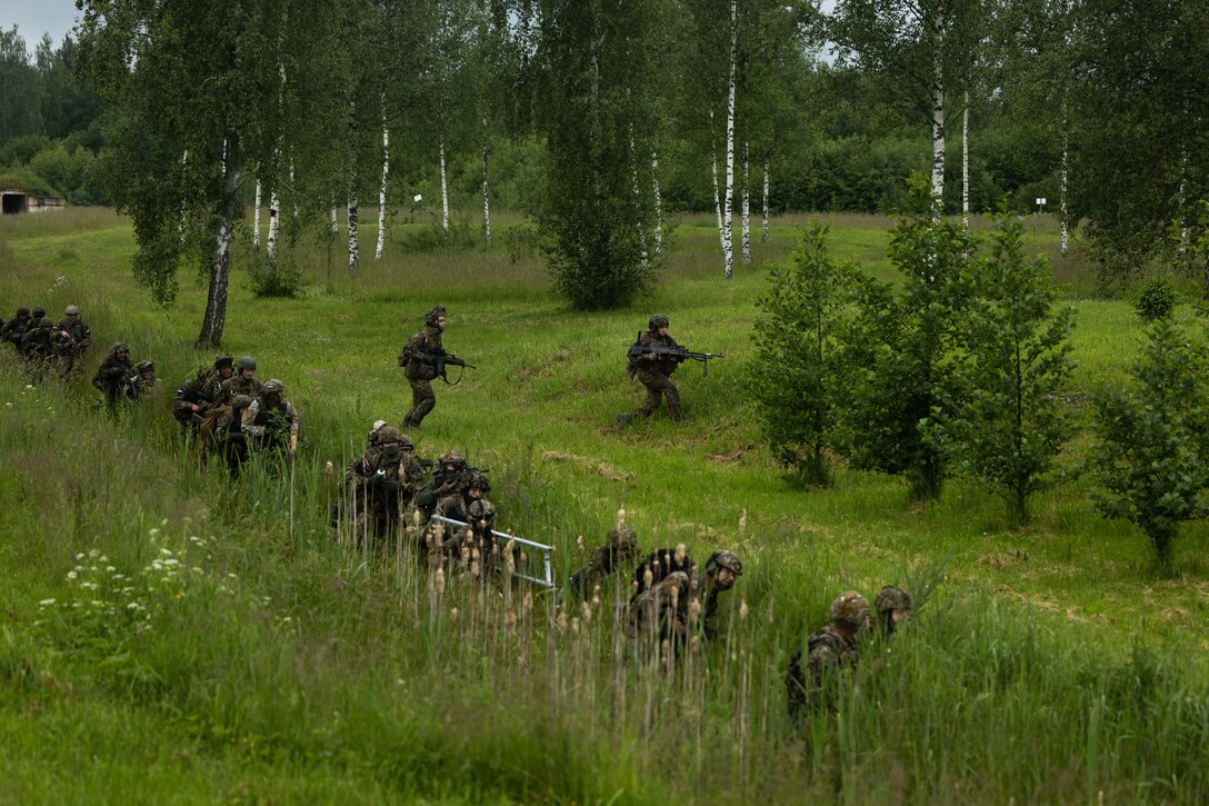 Latvian service members participate in a force-on-force training during exercise Baltic Operations 2025 (BALTOPS 25) in Skrunda, Latvia, June 18, 2025. BALTOPS 25, the premier maritime-focused exercise in the Baltic Region, provides a unique training opportunity to strengthen combined response capabilities critical to preserving freedom of navigation and security in the Baltic Sea. (U.S. Marine Corps photo by Cpl. Xavier Alicea)