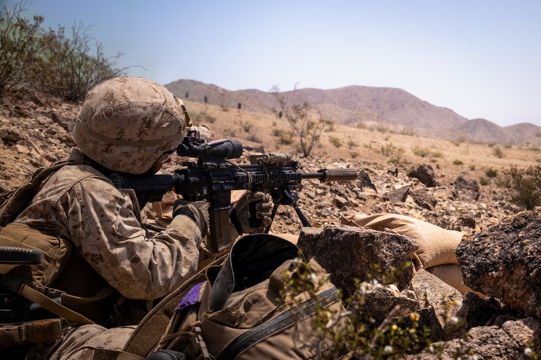 U.S. Marine Corps Lance Cpl. Christopher Carson, an infantryman with 1st Battalion, 23rd Marine Regiment, 4th Marine Division, sights into a rifle at Integrated Training Exercise 3-25 (ITX 3-25) at Marine Corps Air Ground Combat Center, Twentynine Palms, California, June 14th, 2025. ITX is a critical Marine Air-Ground Task Force exercise for the Marine Forces Reserve’s training cycle, confirming unit readiness through live-fire and combined arms integration. (U.S. Marine Corps photo by Lance Cpl. Edward Spears)