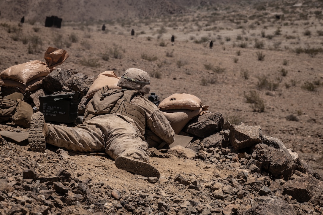 U.S. Marine Corps Pfc. Hayden Travis, a rifleman with 1st Battalion, 23rd Marine Regiment, 4th Marine Division, fires an M27 infantry automatic rifle at Integrated Training Exercise 3-25 (ITX 3-25) at Marine Corps Air Ground Combat Center, Twentynine Palms, California, June 14th, 2025. ITX is a critical Marine Air-Ground Task Force exercise for the Marine Forces Reserve’s training cycle, confirming unit readiness through live-fire and combined arms integration. (U.S. Marine Corps photo by Lance Cpl. Edward Spears)
