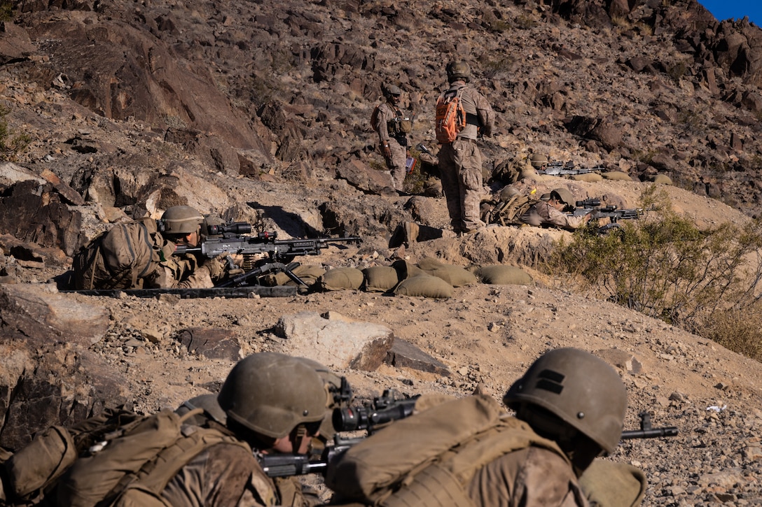 U.S. Marines with 2nd Battalion, 23rd Marine Regiment, 4th Marine Division simulate M240 machine gun suppression on Machine Gun Hill during Integrated Training Exercise 3-25 (ITX 3-25) at Marine Corps Air Ground Combat Center, Twentynine Palms, California, June 15th, 2025.  ITX enhances Marines’ lethality by empowering leaders at every level to adapt, communicate, and execute dynamic movements in hostile environments. (U.S. Marine Corps photo by Lance Cpl. Edward Spears)