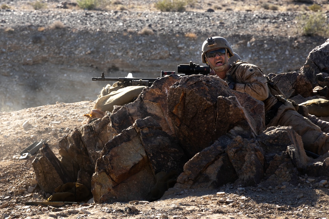 A U.S. Marine with 2nd Battalion, 23rd Marine Regiment, 4th Marine Division communicates target objectives at Range 400 during Integrated Training Exercise 3-25 (ITX 3-25) at Marine Corps Air Ground Combat Center, Twentynine Palms, California, June 15th, 2025. ITX is a critical Marine Air-Ground Task Force exercise for the Marine Forces Reserve’s training cycle, confirming unit readiness through live-fire and combined arms integration. (U.S. Marine Corps photo by Lance Cpl. Edward Spears)
