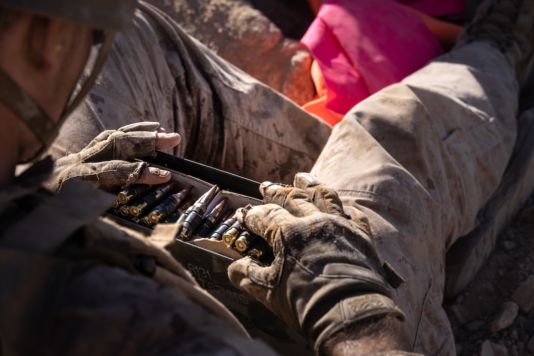 A U.S. Marine with 2nd Battalion, 23rd Marine Regiment, 4th Marine Division prepares ammunition at Range 400 during Integrated Training Exercise 3-25 (ITX 3-25) at Marine Corps Air Ground Combat Center, Twentynine Palms, California, June 15th, 2025. ITX is a critical Marine Air-Ground Task Force exercise for the Marine Forces Reserve’s training cycle, confirming unit readiness through live-fire and combined arms integration. (U.S. Marine Corps photo by Lance Cpl. Edward Spears)