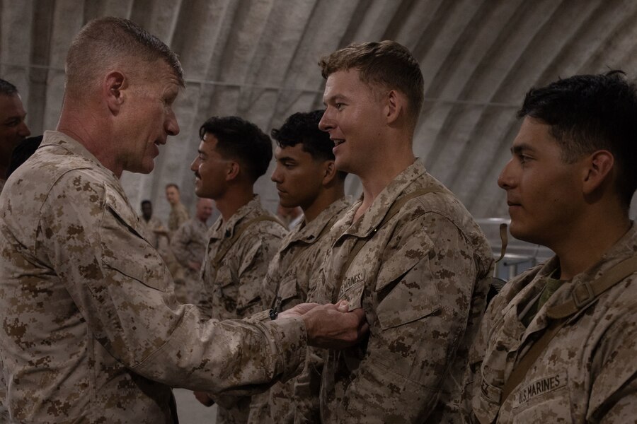 U.S. Marine Corps Brig. Gen. John K. Jarrard, commanding general of 4th Marine Division, awards Marines with 1st Battalion, 23rd Marine Regiment at Integrated Training Exercise 3-25 (ITX 3-25) at Marine Corps Air Ground Combat Center, Twentynine Palms, California, June 15th, 2025. The medal was awarded for winners of a squad competition that tested Marines' physical fitness levels, tactical proficiency, and unit cohesion. ITX is a critical Marine Air-Ground Task Force exercise for the Marine Forces Reserve’s training cycle, confirming unit readiness through live-fire and combined arms integration. (U.S. Marine Corps photo by Lance Cpl. Edward Spears)