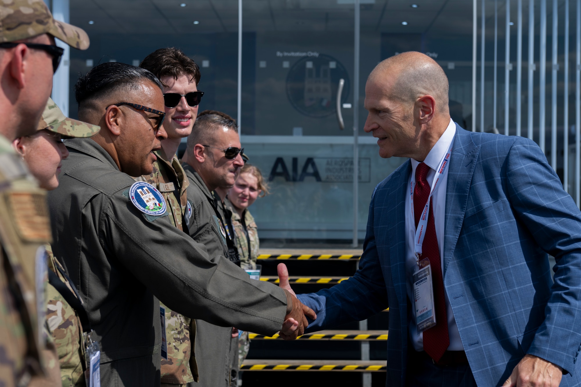 A man greeting several service members