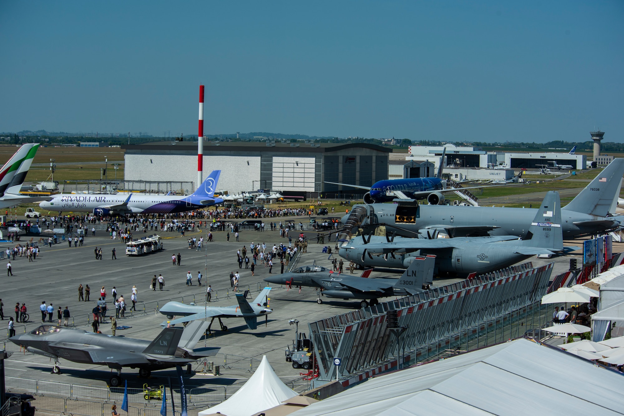 several aircrafts and people at an airshow