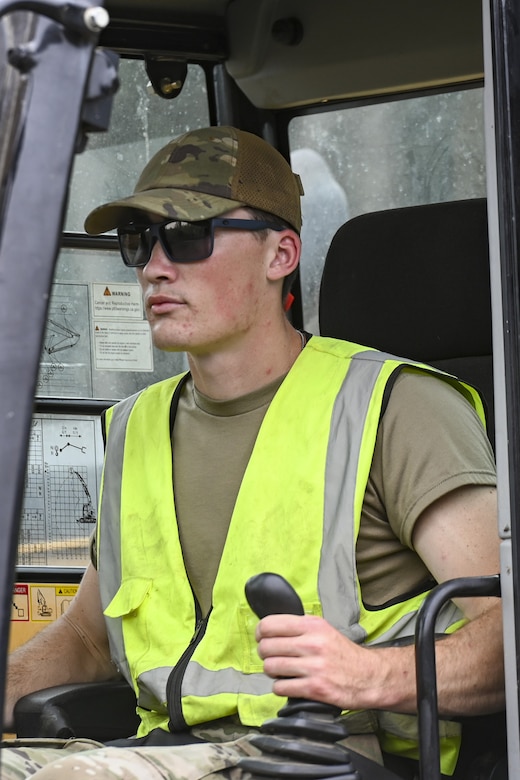Pennsylvania Air National Guardsman, Senior Airman John Trimbath, assigned to the 171st Civil Engineer Squadron, operates an excavator during a deployment for training, Assateague Island, Virginia, June 17, 2025. The 171st engineers are the 5th rotation of 8 during the deployment for training on the island. The DFT has provided engineers with unique training consistent with installing a runway while creating a new road for the Fish and Wildlife Service. (U.S. Air National Guard photo by Senior Master Sgt. Bryan Hoover)