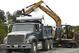 Pennsylvania Air National Guardsman, Senior Airman John Trimbath, assigned to the 171st Civil Engineer Squadron, loads debris into a dump truck while operating an excavator during a deployment for training, Assateague Island, Virginia, June 17, 2025. The 171st engineers are the 5th rotation of 8 during the deployment for training on the island. The DFT has provided engineers with unique training consistent with installing a runway while creating a new road for the Fish and Wildlife Service. (U.S. Air National Guard photo by Senior Master Sgt. Bryan Hoover)