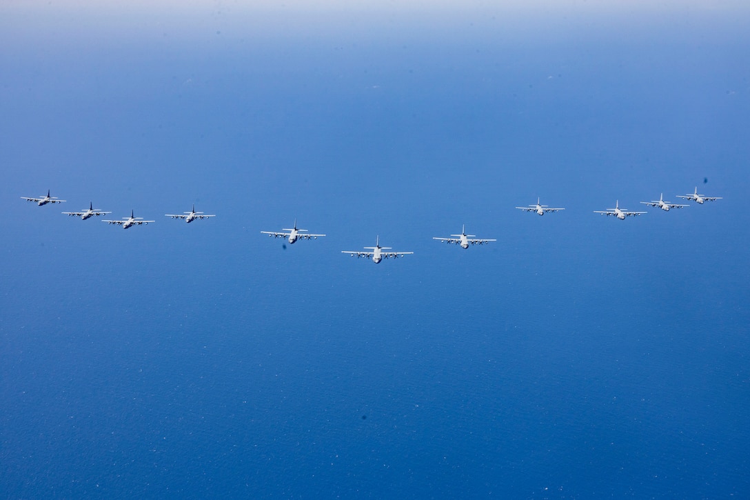 U.S. Marines with Marine Aerial Refueler Transport Squadron (VMGR) 252 fly KC-130J Super Hercules in formation near Marine Corps Air Station Cherry Point, North Carolina, June 18, 2025. VMGR-252 conducted surge operations to exercise their ability to launch and recover multiple divisions of aircraft concurrently. (U.S. Marine Corps photo by Lance Cpl. Bryan Giraldo)