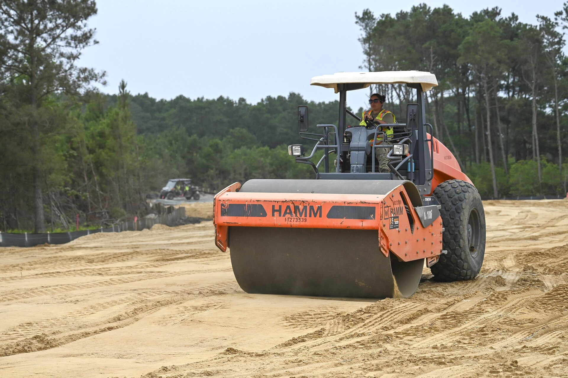 Pennsylvania Air National Guardsman, Tech, Sgt. Mary Connelly, assigned to the 171st Civil Engineer Squadron, operates a road roller to create a compact driving surface for other vehicles during a deployment for training, Assateague Island, Virginia, June 17, 2025. The 171st engineers are the 5th rotation of 8 during the deployment for training on the island. The DFT has provided engineers with unique training consistent with installing a runway while creating a new road for the Fish and Wildlife Service. (U.S. Air National Guard photo by Senior Master Sgt. Bryan Hoover)