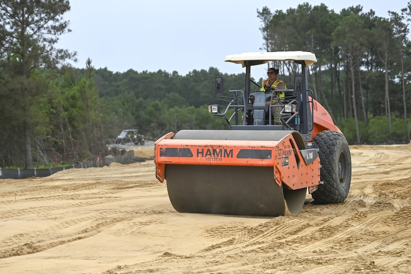 Pennsylvania Air National Guardsman, Tech, Sgt. Mary Connelly, assigned to the 171st Civil Engineer Squadron, operates a road roller to create a compact driving surface for other vehicles during a deployment for training, Assateague Island, Virginia, June 17, 2025. The 171st engineers are the 5th rotation of 8 during the deployment for training on the island. The DFT has provided engineers with unique training consistent with installing a runway while creating a new road for the Fish and Wildlife Service. (U.S. Air National Guard photo by Senior Master Sgt. Bryan Hoover)