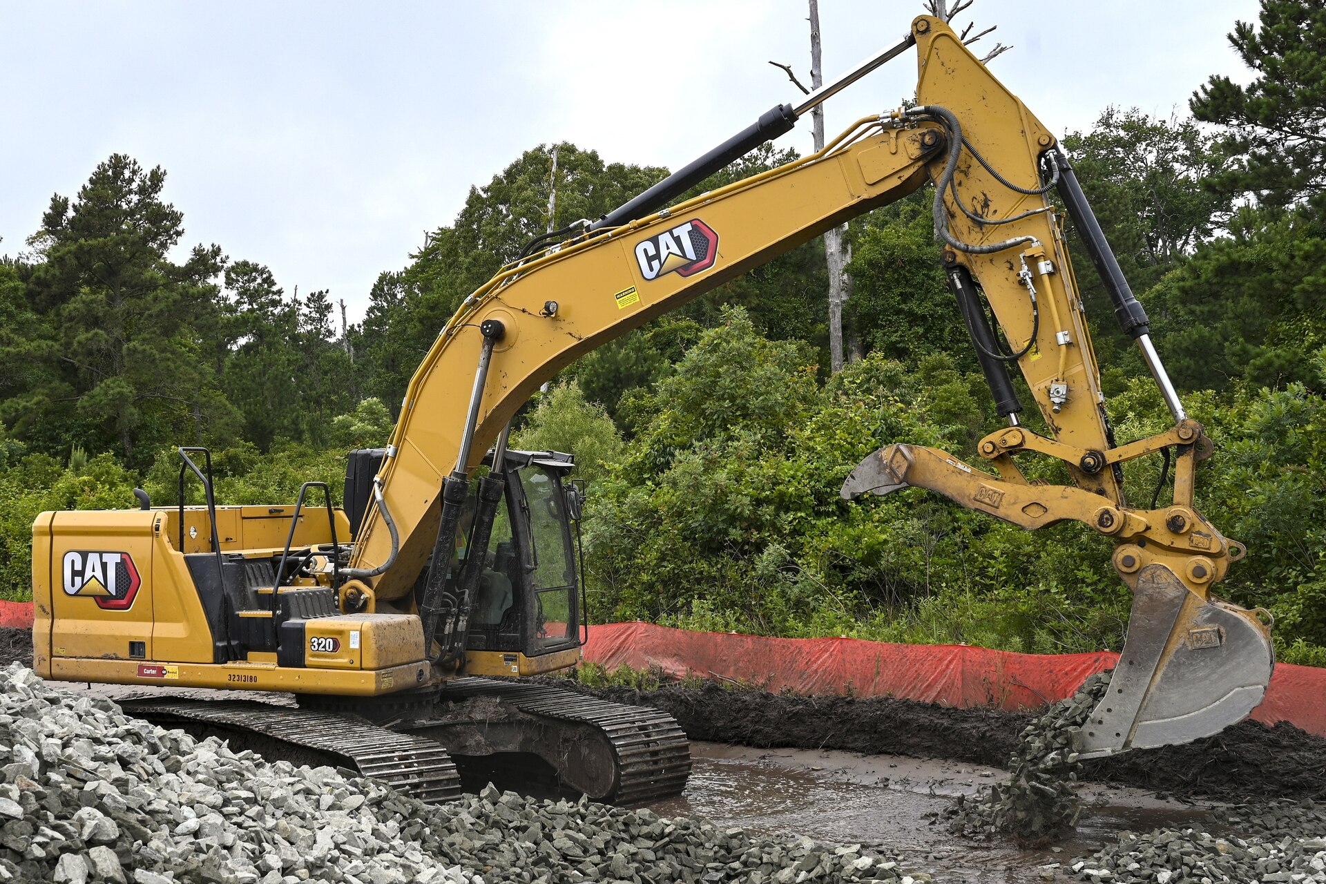 Pennsylvania Air National Guardsman, Senior Airman Asa Henderson assigned to the 171st Civil Engineer Squadron, operates an excavator to move riprap during a deployment for training, Assateague Island, Virginia, June 17, 2025. The 171st engineers are the 5th rotation of 8 during the deployment for training on the island. The DFT has provided engineers with unique training consistent with installing a runway while creating a new road for the Fish and Wildlife Service. (U.S. Air National Guard photo by Senior Master Sgt. Bryan Hoover)