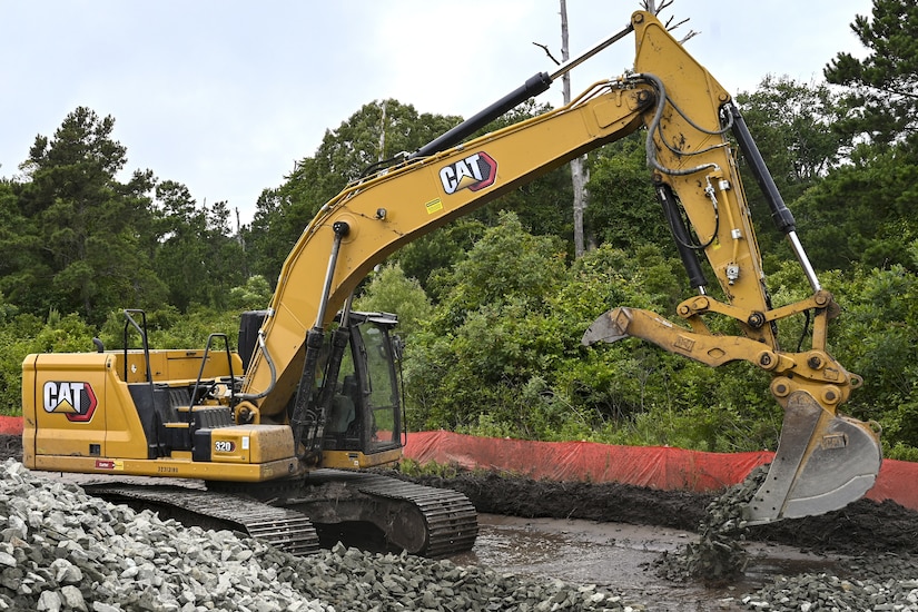 Pennsylvania Air National Guardsman, Senior Airman Asa Henderson assigned to the 171st Civil Engineer Squadron, operates an excavator to move riprap during a deployment for training, Assateague Island, Virginia, June 17, 2025. The 171st engineers are the 5th rotation of 8 during the deployment for training on the island. The DFT has provided engineers with unique training consistent with installing a runway while creating a new road for the Fish and Wildlife Service. (U.S. Air National Guard photo by Senior Master Sgt. Bryan Hoover)