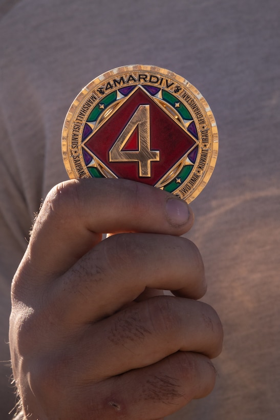 U.S. Marine Corps Capt. Hunter Doliber, a company commander in 4th Light Armored Reconnaissance Battalion, 4th Marine Division, receives a challenge coin from Brig. Gen. John K. Jarrard, commanding general of 4th Marine Division, at Integrated Training Exercise 3-25 (ITX 3-25) at Marine Corps Air Ground Combat Center, Twentynine Palms, California, June 16th, 2025. ITX is a critical Marine Air-Ground Task Force exercise for the Marine Forces Reserve’s training cycle, confirming unit readiness through live-fire and combined arms integration. (U.S. Marine Corps photo by Lance Cpl. Edward Spears)