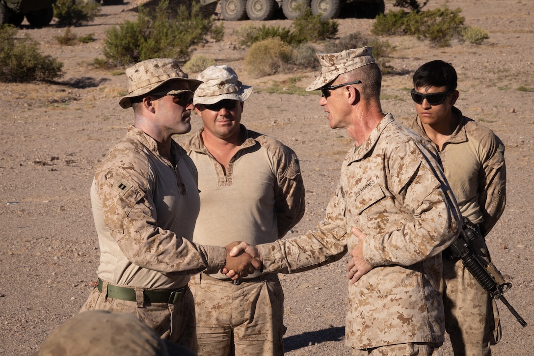 U.S. Marine Corps Capt. Hunter Doliber (left), a company commander in 4th Light Armored Reconnaissance Battalion, 4th Marine Division, receives a challenge coin from Brig. Gen. John K. Jarrard, commanding general of 4th Marine Division, at Integrated Training Exercise 3-25 (ITX 3-25) at Marine Corps Air Ground Combat Center, Twentynine Palms, California, June 16th, 2025. ITX is a critical Marine Air-Ground Task Force exercise for the Marine Forces Reserve’s training cycle, confirming unit readiness through live-fire and combined arms integration. (U.S. Marine Corps photo by Lance Cpl. Edward Spears)